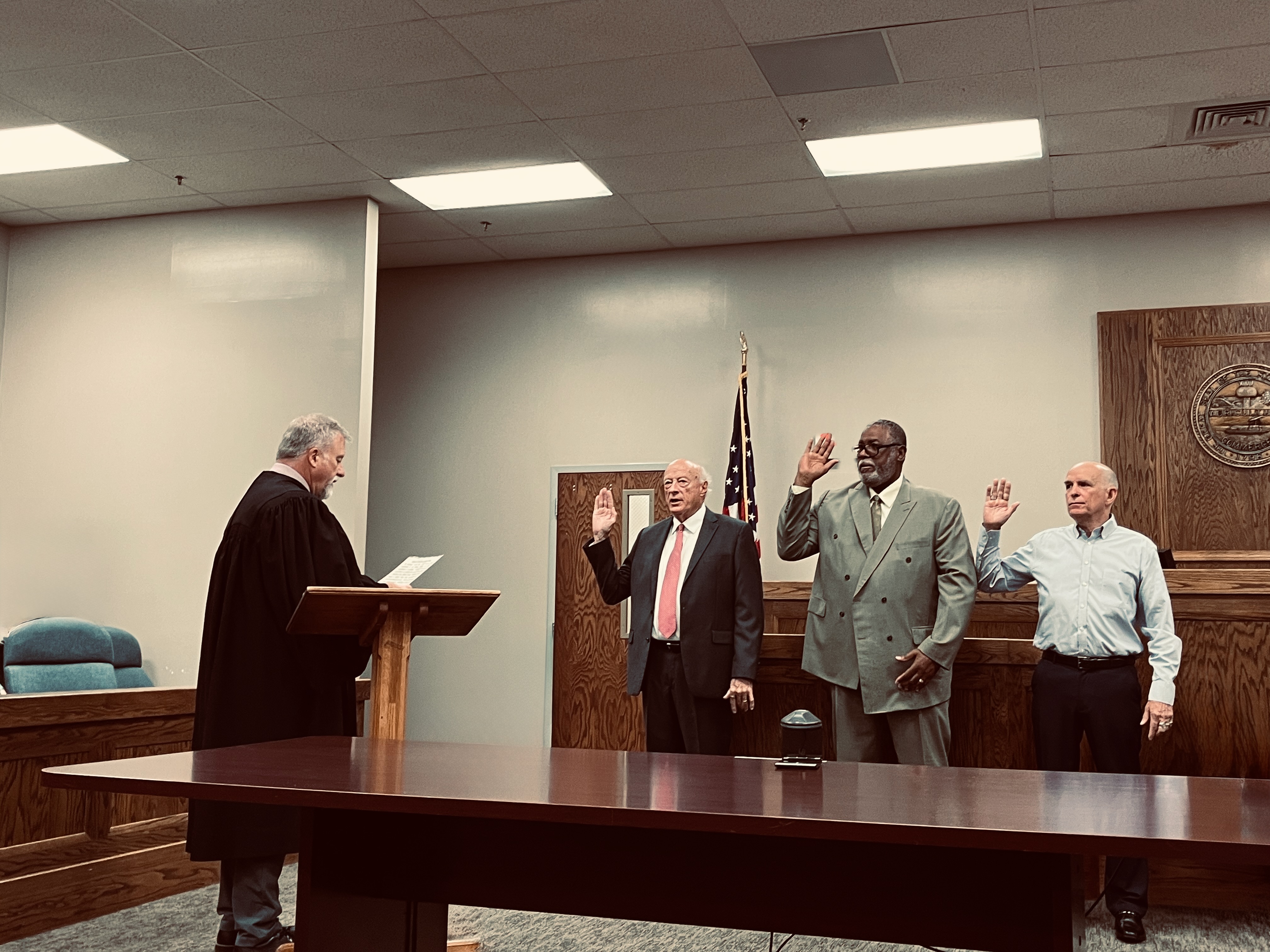 Three founding Veterans Court Board members taking the oath of office with raised hands before Judge Eckel in the General Sessions courtroom